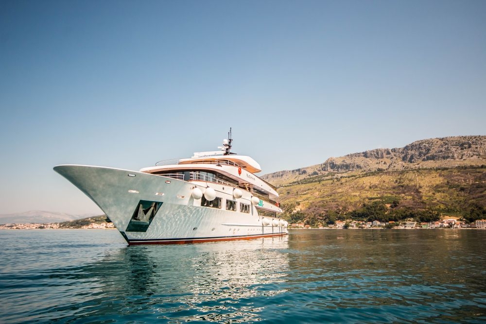 A beautiful image of The Black Swan docked near a Croatian island.