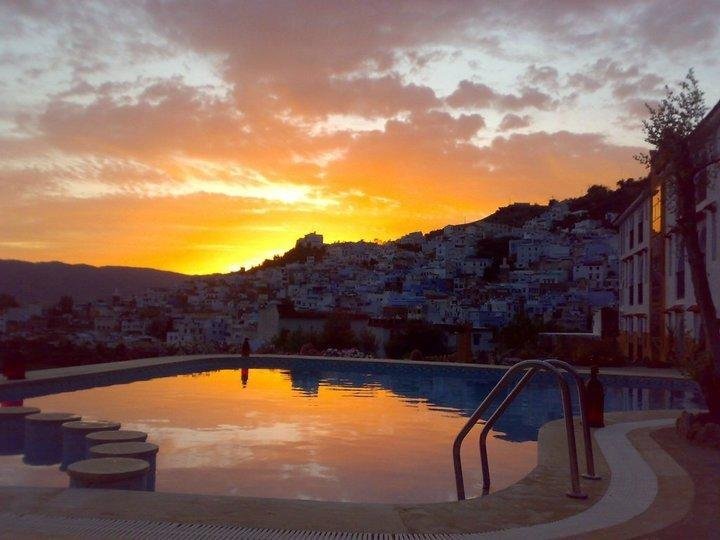 Sunset behind Chefchaouen. Hotel pool in the foreground.