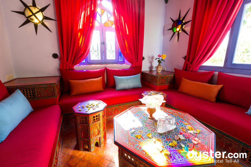 A lounge area at our Chefchaouen accommodations decorated with red linens and cushions.