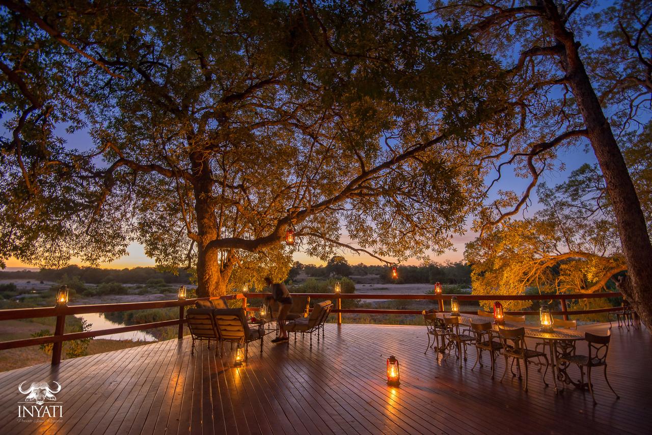 Inyati Safari Lodge's terrace is lit up by candles.