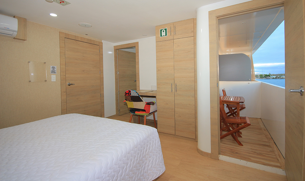 An interior photo showcasing a Balcony Suite aboard the Grand Queen Beatriz.