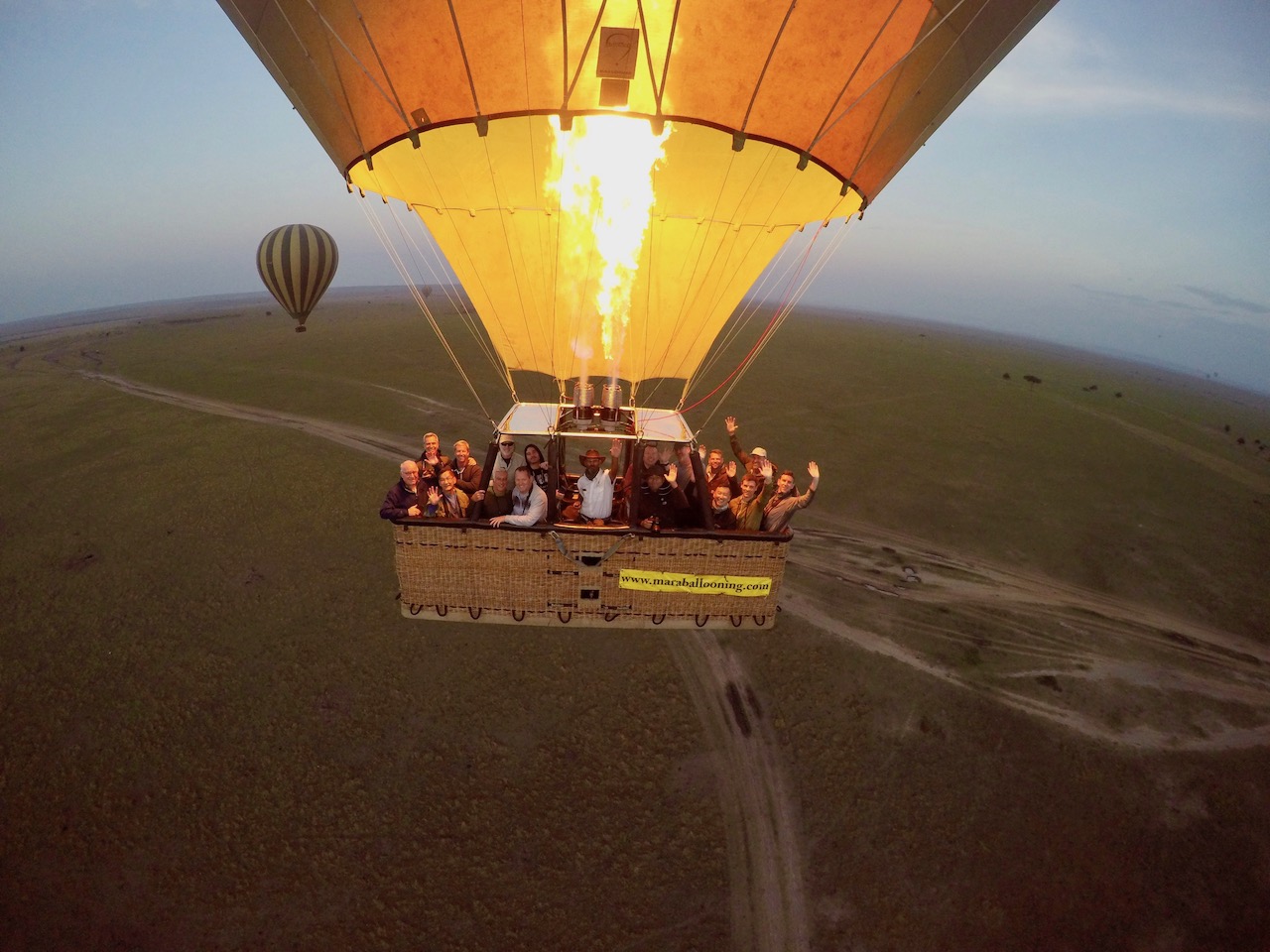 An Out Adventures group take a photo together while riding in a hot air balloon above Kenya.