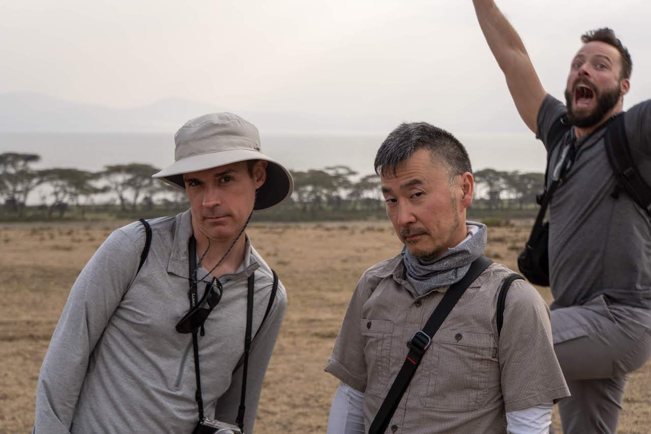 Three gay men posing peculiarly in Kenya.