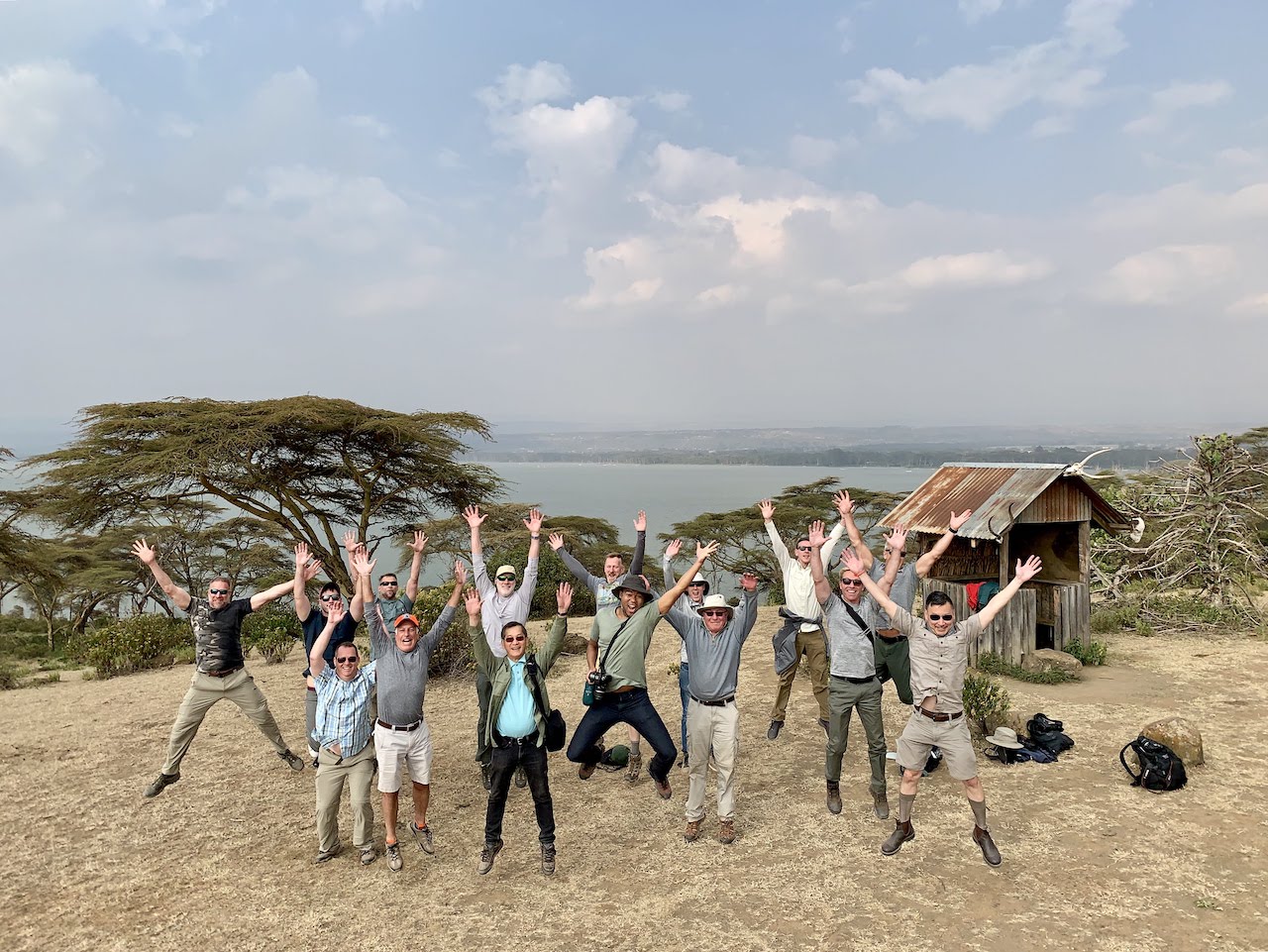 Out Adventures gay travellers jump for joy in unison over Lake Nakuru.